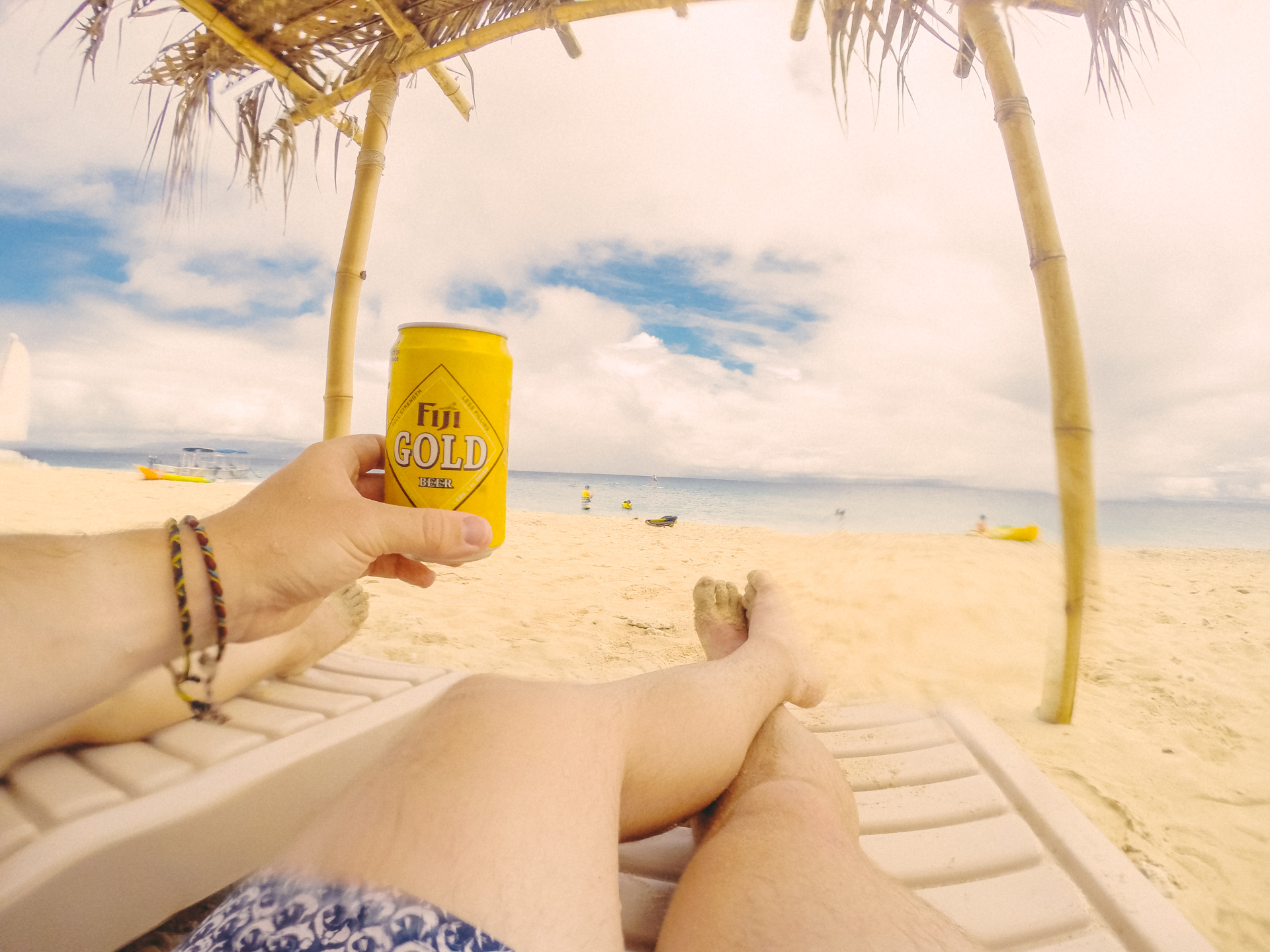 Drinking Fiji Gold Beer on golden beach of South Sea Island, Fiji