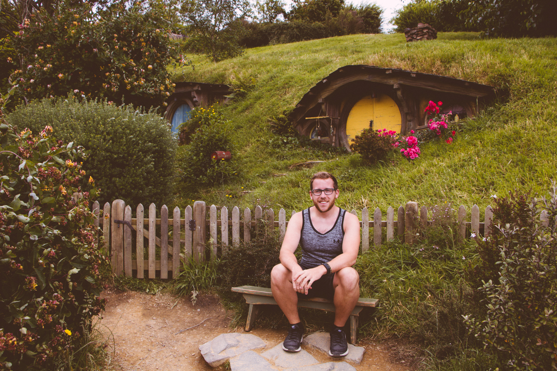Alex at a hobbit hole Hobbiton