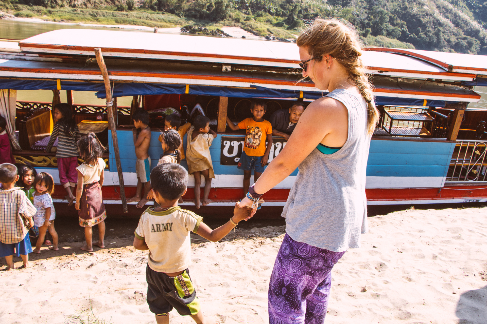 Alis and Village boy by boat on Mekong River