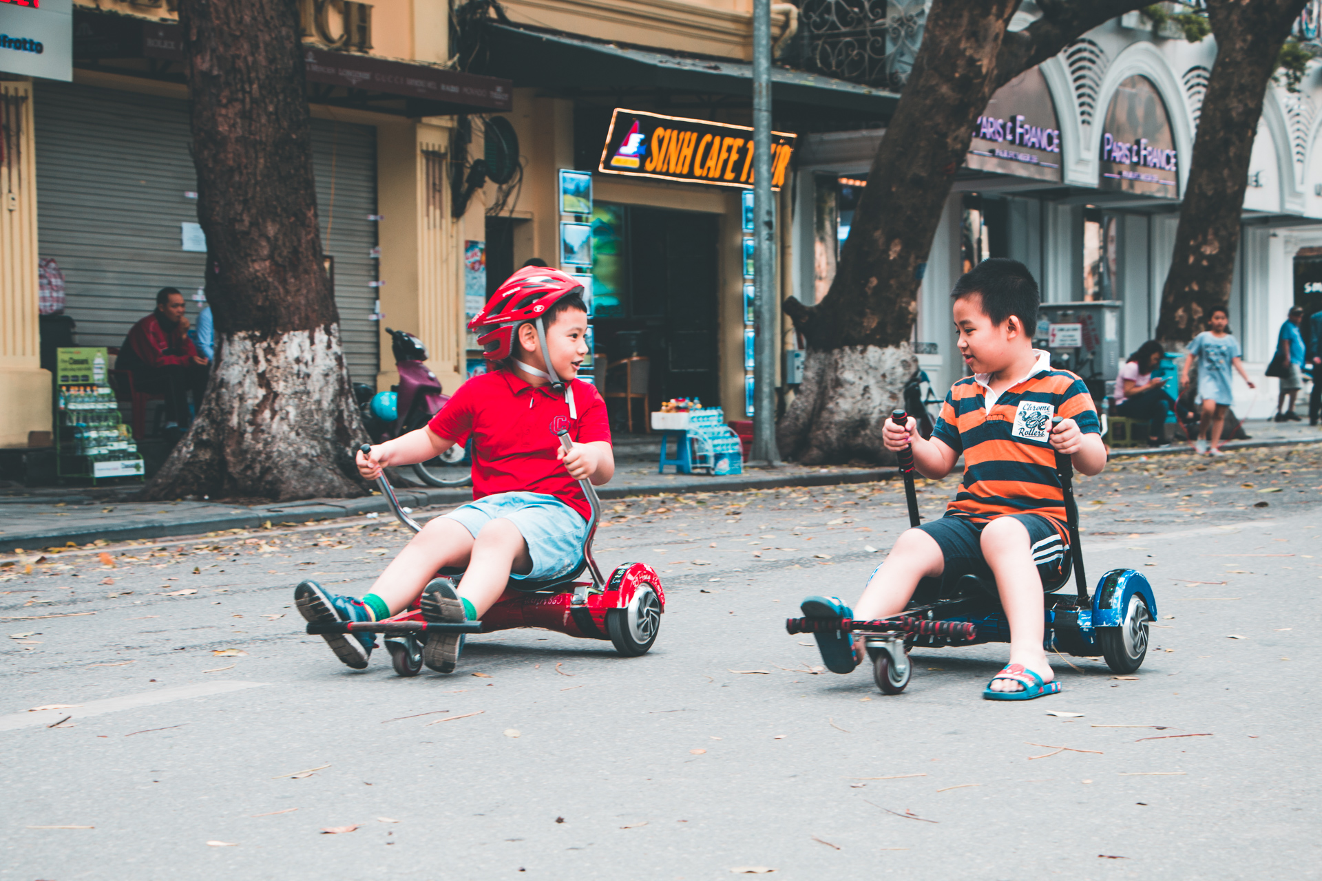 Children Playing on Sitdown Swegways in Hanoi