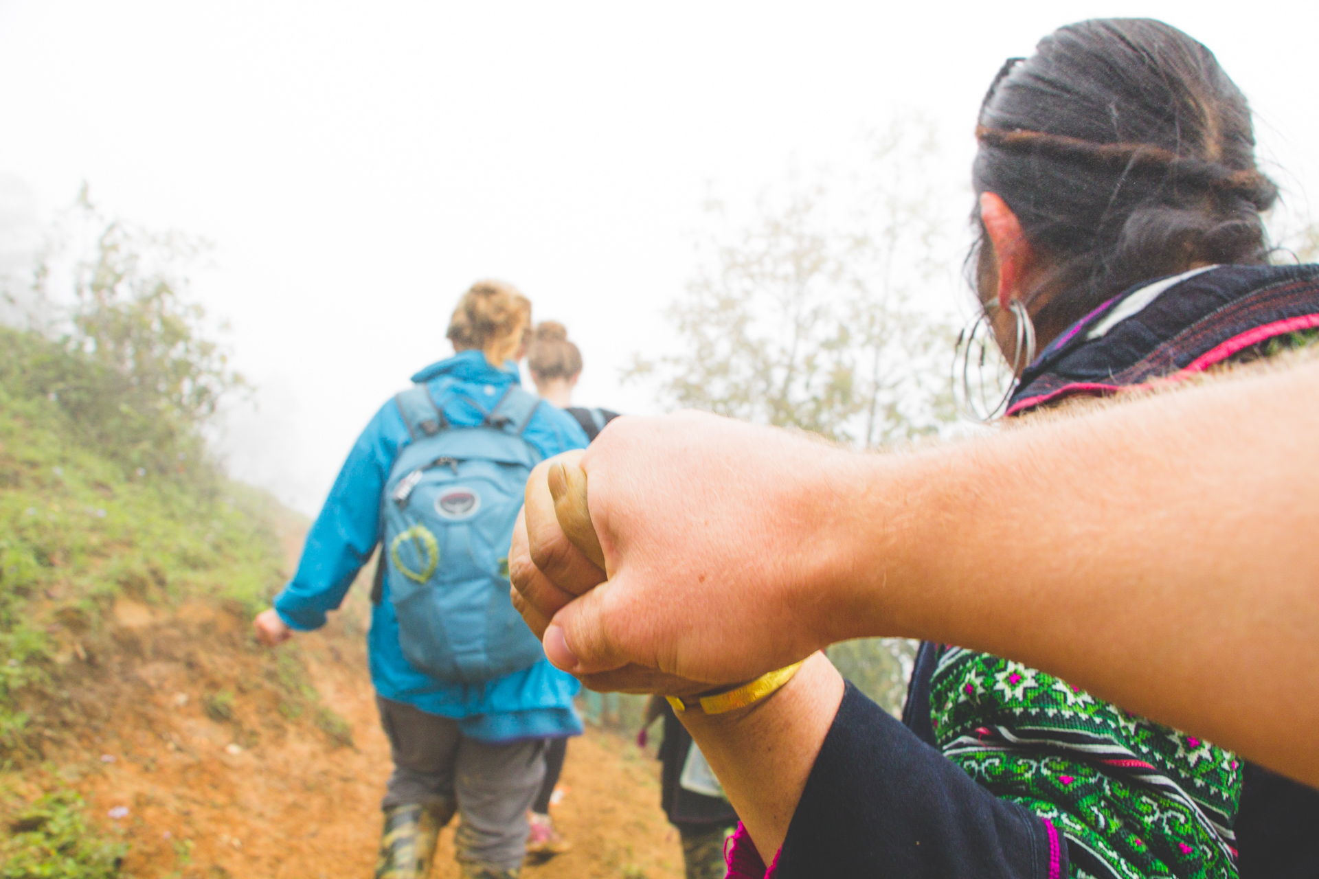 Sapa villager holding hand on way down